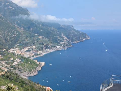 Scenic view of a coastline with buildings and hills