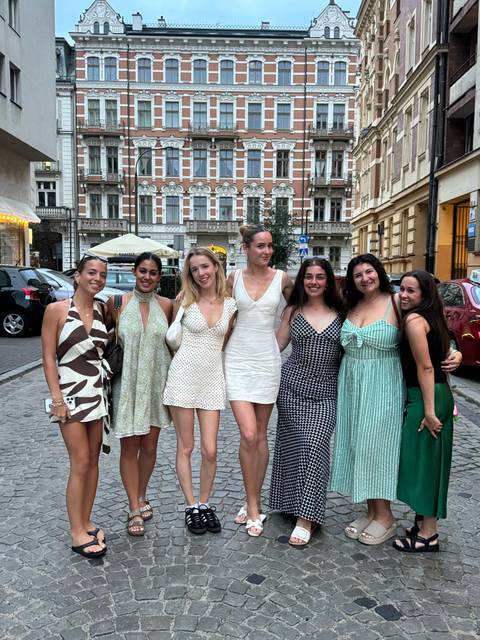 Group of young women posing on a city street
