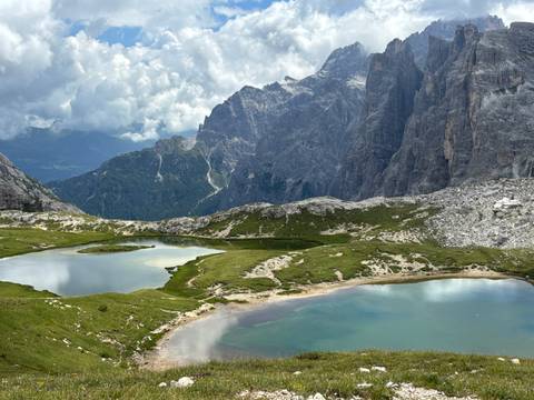       A breathtaking view of two mountain lakes surrounded by towering peaks.
  