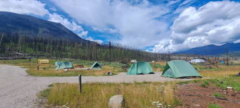 Campsite with tents in a mountainous area.