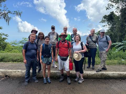 A group of hikers posing on a mountain trail.