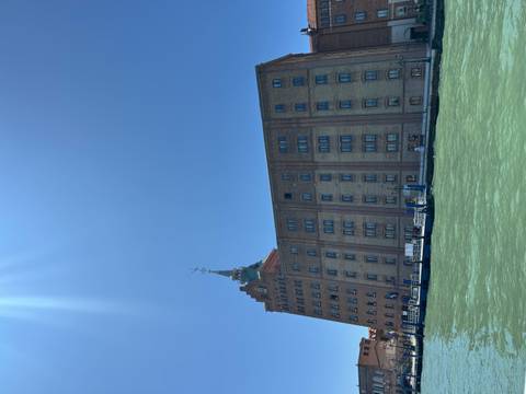 Mestre building with blue sky and water view.