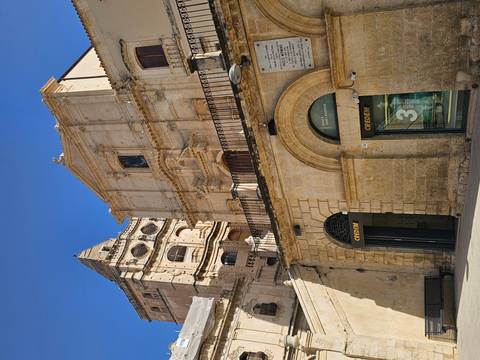 Historic sandstone building with a clock tower.