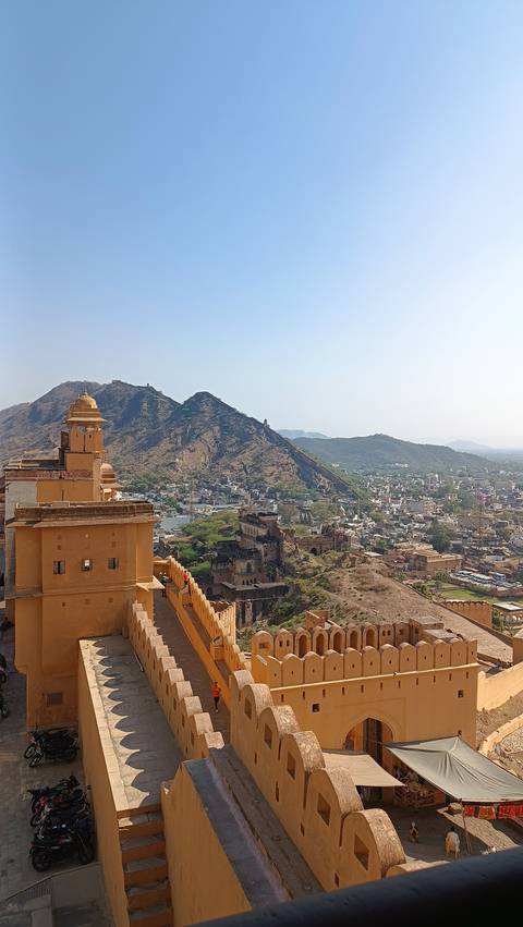 Aerial view of a fort complex with hills and city below.