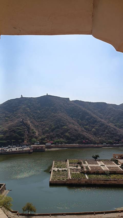 Great wall stretching over forested hills, with watchtowers.