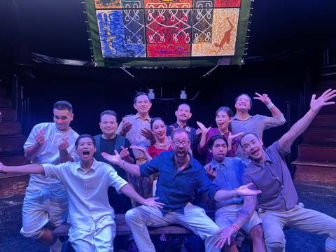       Group of people posing with theatrical expressions.
  