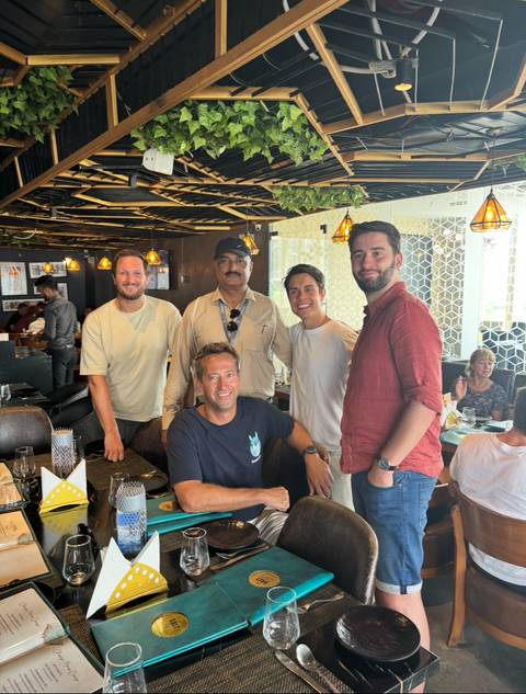 Group of people dining in a restaurant setting.