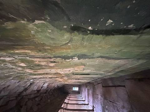 Interior corridor of an ancient stone temple.