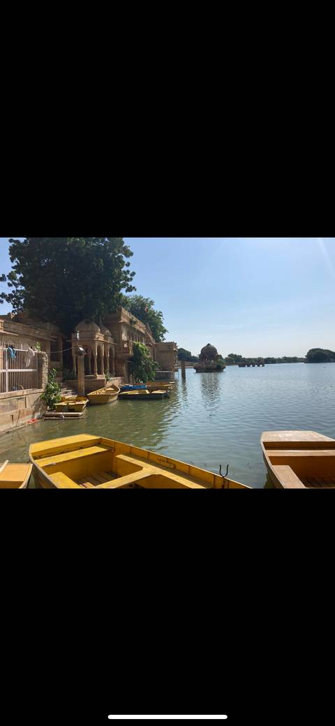 Historic site by a lake with small boats.