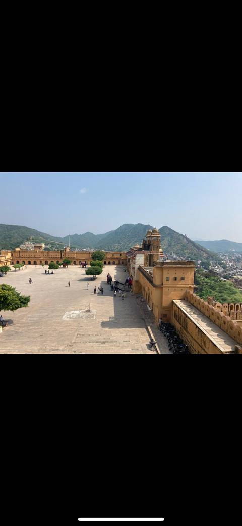Courtyard of Amber Fort with people and scenic views.
