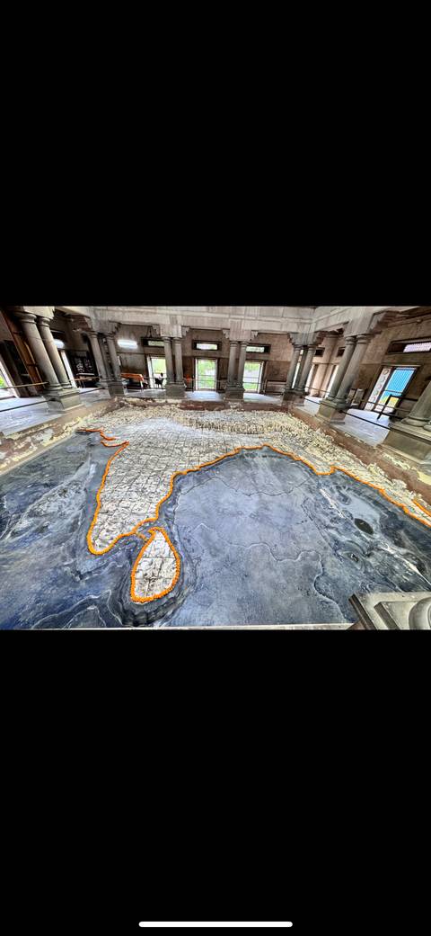 Map of India carved on the ground with surrounding columns.