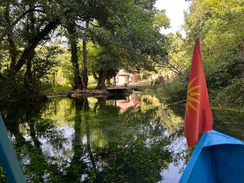 Clear stream with reflection, seen from a boat.