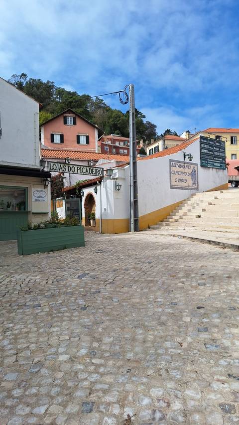 Street view showing restaurants and shops.
