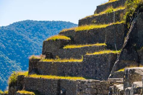 Terraced stone structure with mountain view.
