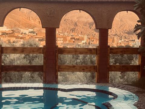       View from an arched window over a desert town.
  