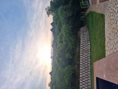 Scenic view of buildings on a hill at sunset.