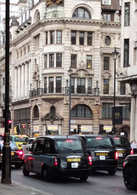 Blurry image of an urban street with historical buildings.