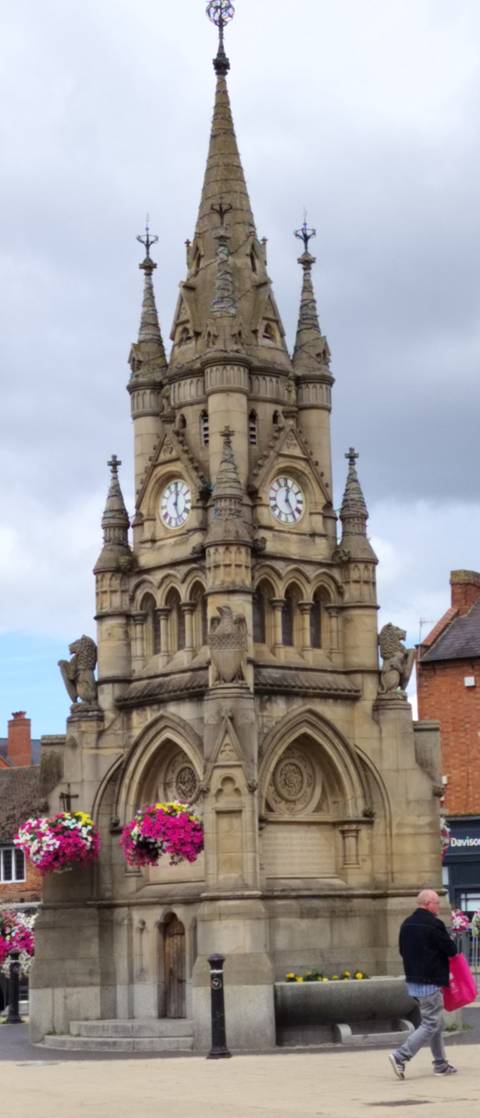 Blurry image of a clock tower on a historical building.