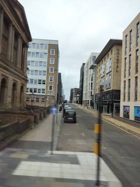 Street view with modern buildings, slightly blurry.