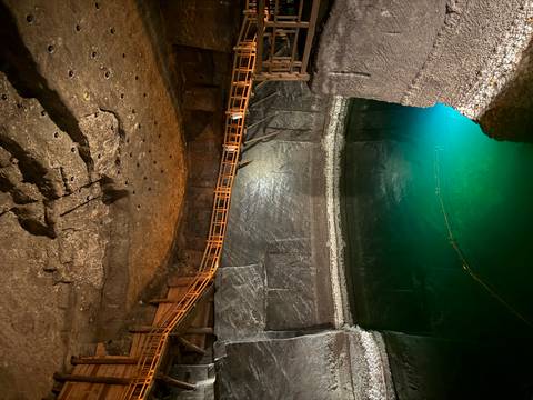       Cave with an illuminated underground pool.
  