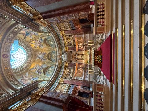       Opulent interior of a cathedral with intricate decorations.
  