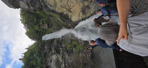       Tourists viewing a large waterfall
  