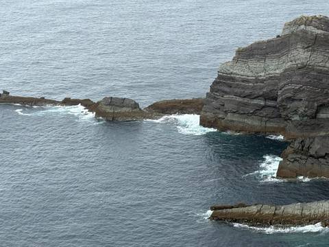 Cliffside by the ocean with layers of rock