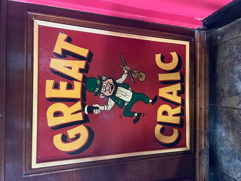 Sign with a cartoon character and slogan in vibrant colors.