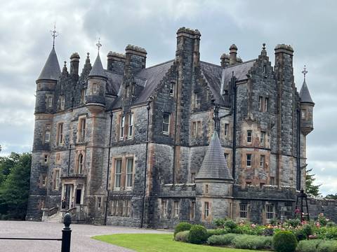 Imposing Gothic-style castle with multiple turrets and detailed stonework.