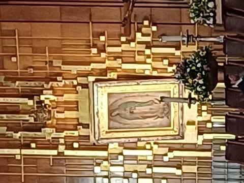 Blurry image of religious artwork with golden framing.