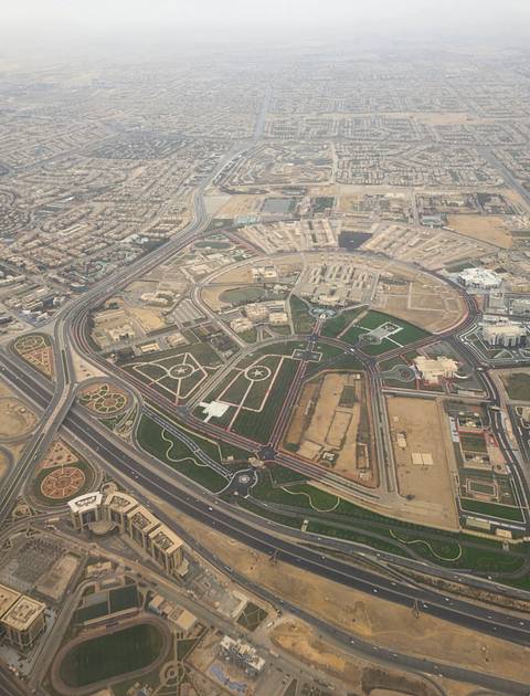       Aerial view of a cityscape with various buildings and roads.
  