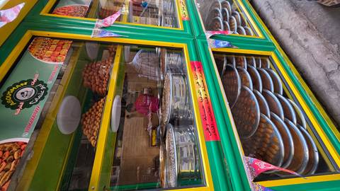       Pastry shop with assorted sweets in display cases.
  