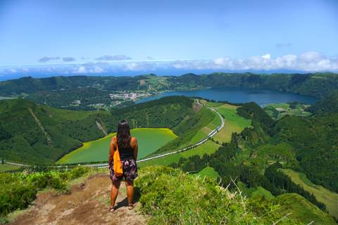 Person overlooking a scenic view of lakes and mountains in São Miguel Island.