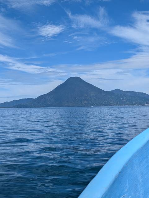 Volcanic mountain view over a lake under a clear sky