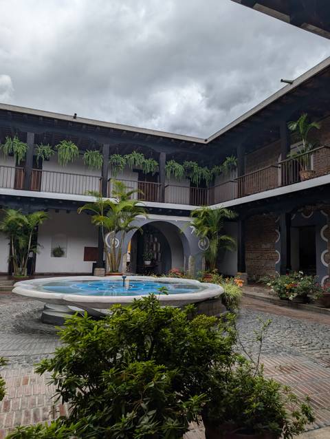 Courtyard with a central fountain and hanging plants