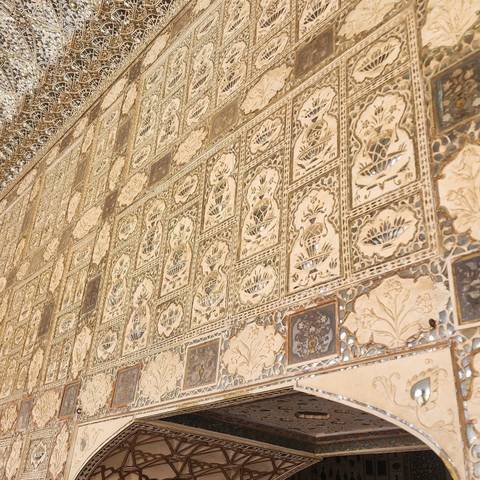Intricate decorative design details on a wall at the Amer Fort in Jaipur.