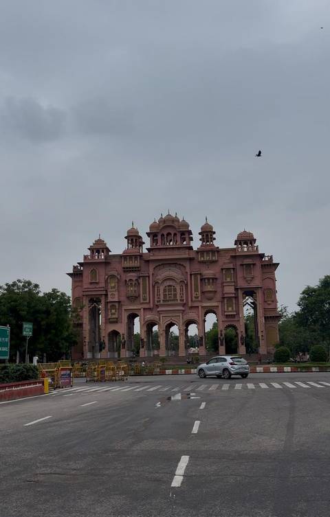 Pink colored gate with intricate architecture, possibly in Jaipur.