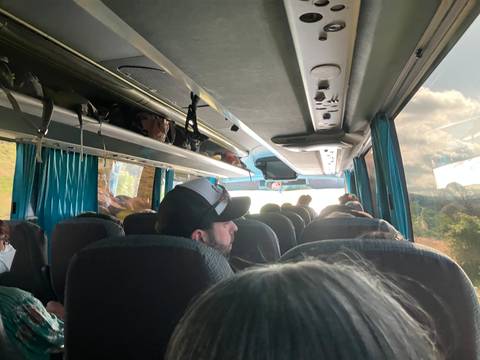 Interior of a bus with passengers seated.