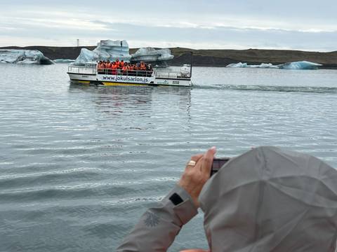 Boat tour among icebergs on a glacial lagoon.