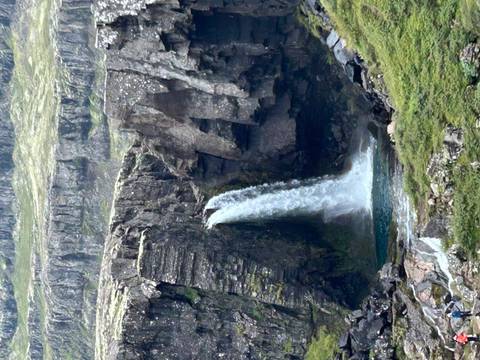 Waterfall cascading down a rocky cliff.