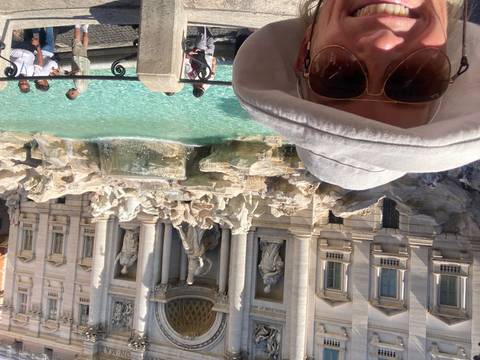Trevi Fountain with tourists taking photos.