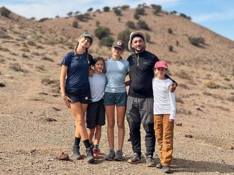 A family posing in a desert landscape.