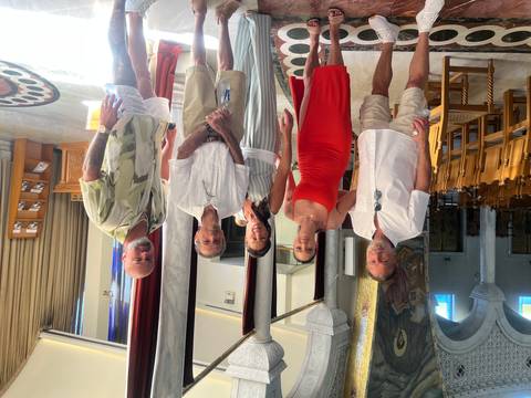 A group posing inside a decorated building.