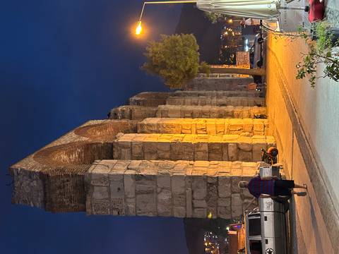       Ancient aqueduct lit at night.
  