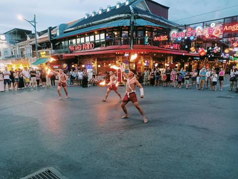       Street performers demonstrating fire tricks.
  