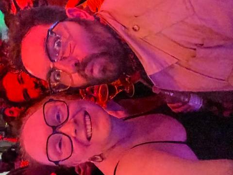       Two people in a vibrant and colorful party.
  