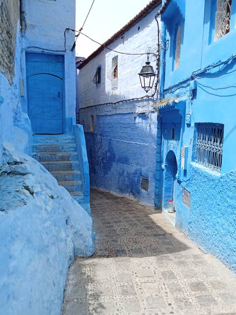       Traditional clothing mannequins displayed on the street.
  
