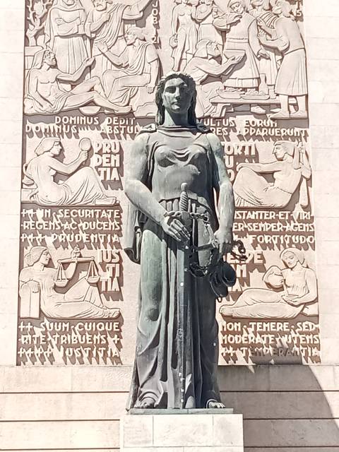       Large group of tourists posing for a photo on a parking lot.
  