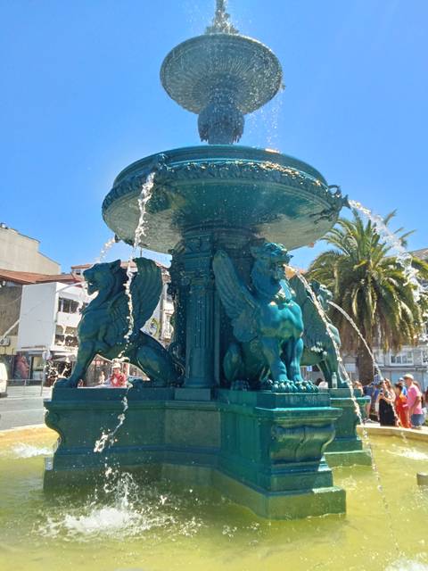       Turquoise fjord with a backdrop of steep mountains.
  