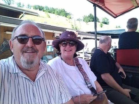 A couple sitting at an outdoor restaurant table.
